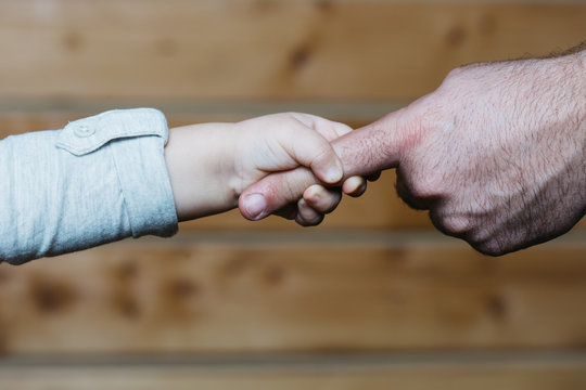 Hands of son and father