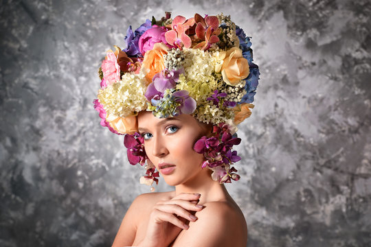 Young woman with luxuriant wig made of flowers