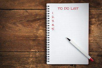 writing to do list on notepad with pen