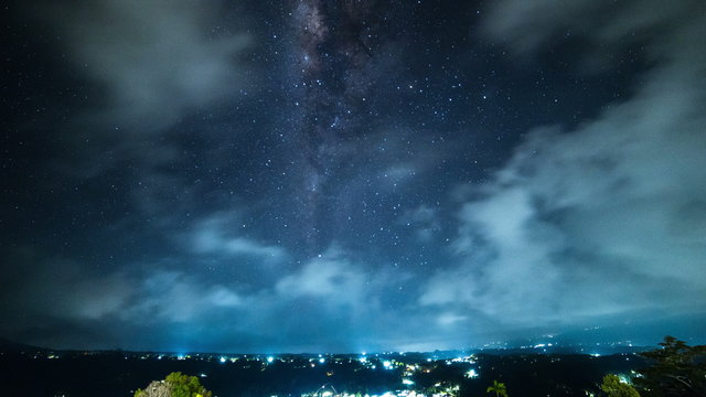 4K Timelapse. The Milky Way with clouds above the village in a mountainous area. 15 July 2015, Bali, Indonesia
