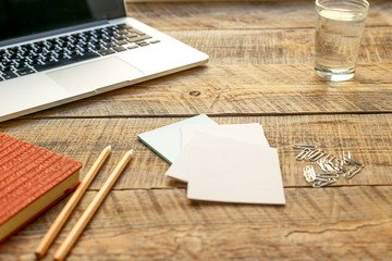 Comfortable working place with wooden table and laptop at sunlight
