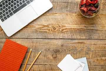 Comfortable working place with wooden table and laptop at sunlight