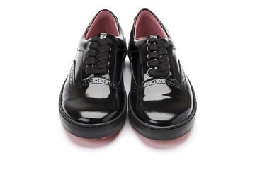 girls black school shoes on a white background