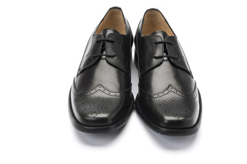 girls black school shoe on a white background