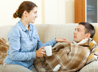 wife giving  tablets to her husband