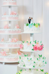 Wedding cake decorated with bride and groom figurines