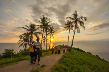 a couple enjoy sunset by the seaside