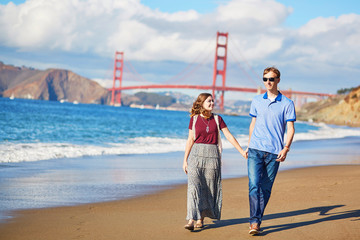 Romantic loving couple having a date on Baker beach in San Francisco