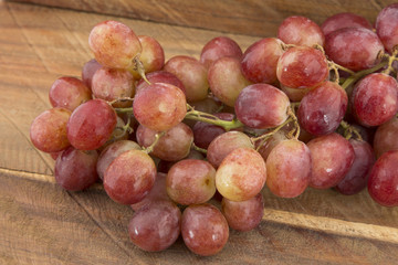 Delicious grapes on wooden background