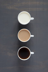 Three cups with milk and coffee