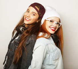 lifestyle portrait of two pretty teen girlfriends smiling and ha