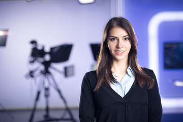 Television presenter recording in news studio.Female journalist anchor presenting business...