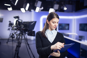 Woman journalist working as reporter,correspondent or broadcast news analysts in TV studio.Public...
