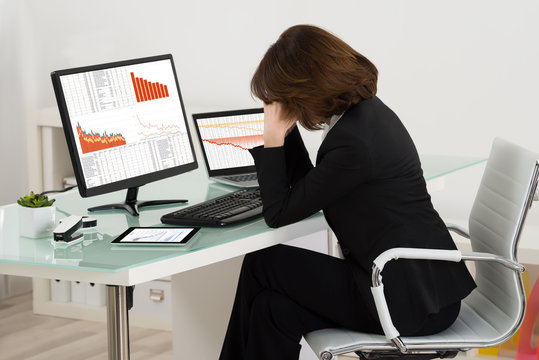 Businesswoman Suffering From Headache In Office