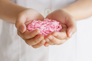 many medicine pills in doctor hands