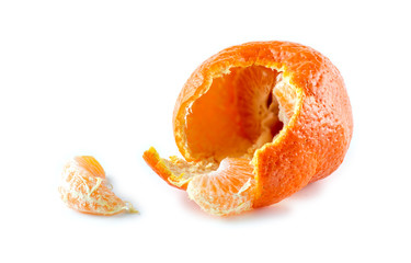 Mandarin with half peeled skin and pieces of citrus against whit
