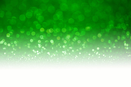 Green glitter surface with green light bokeh with white copyspace