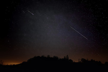 Two Meteros In Night Sky Of Stars, Sillouete Of Landscape