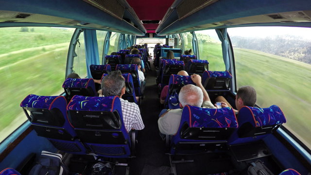 Luxury tourist bus full of passengers traveling in Alps