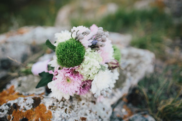 Beautiful wedding couple with bouquet flowers on the sunset