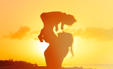 mother and daughter having fun at sunset