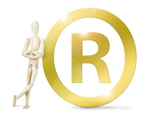Man leaned against a huge golden Registered sign. Abstract image with a wooden puppet
