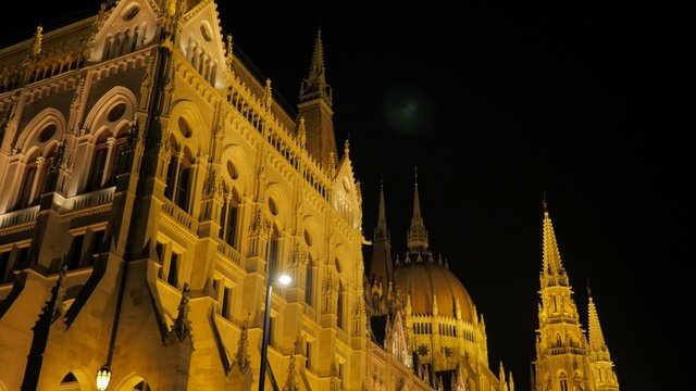 Hungarian national parliament located on river Danube and city of Budapest by the night 4K 2160p UltraHD footage - Lighted by night Budapest famous national parliament building 4K 3840X2160 UHD video 