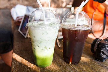 Green tea and iced tea with mirrorless camera and tablet