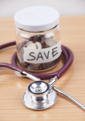 Bottles of coins for Health care cost saving