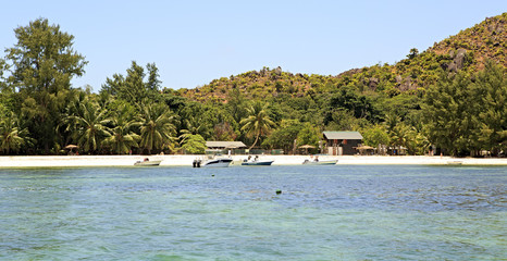 Boats at the beautiful beach of Curieuse Island in Indian Ocean.