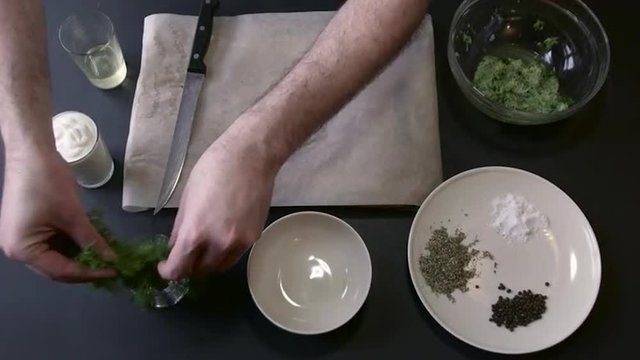Male Cook Cut Dill on Boards Knife