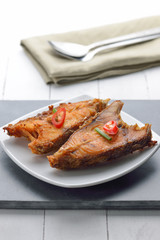 Fried fish on plate on white plate