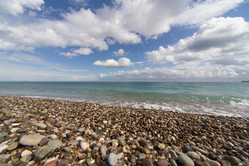 Fototapeta na wymiar Beautiful sea paradise beach on a background of blue sky with clouds.