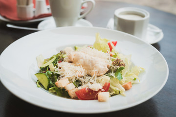 Caesar salad and a cup of coffee