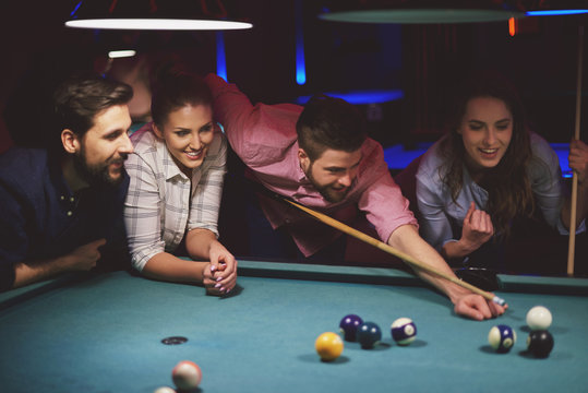 Group of friends playing pool game