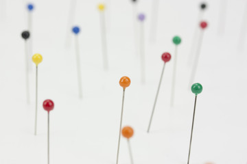 Different coloured pins on a light background