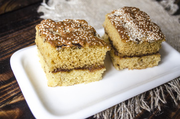 White porcelain plate with sliced biscuit cakes
