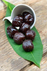 Red date - sugar preserved fruit on wood background