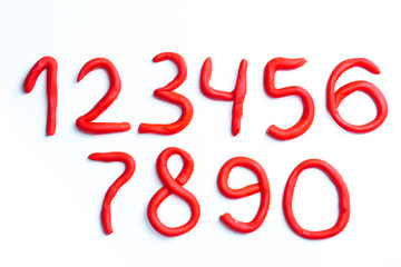 Red plasticine numbers on white background