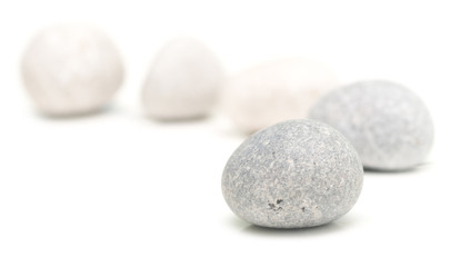 Fototapeta na wymiar round stones on white