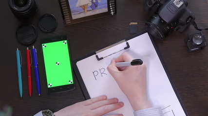 A man writes a pen on paper word project