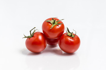 Bunch of the fresh tomatoes  isolated on white