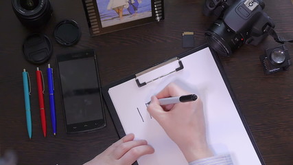 A man writes a pen on paper word idea