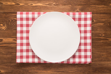 Empty plate on wooden table 