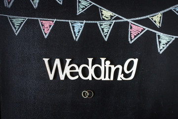 Fototapeta na wymiar Chalkboard background with drawing bunting flags. Rings and wedd