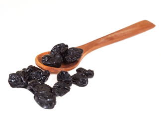 Raisin in wood spoon on the white background