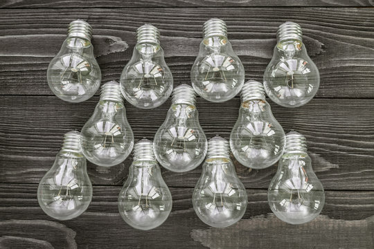 incandescent lamps on the wooden rustic background