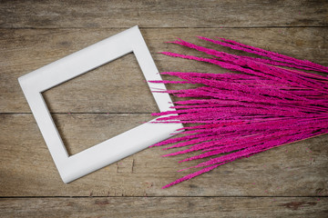 Closeup pink grass flowers on wooden background