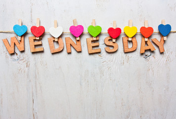 Wednesday word from wooden letters on a white wooden background