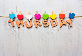 word Thursday from wooden letters on a white wooden background